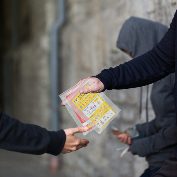 drug deal in alley way with safety cards
