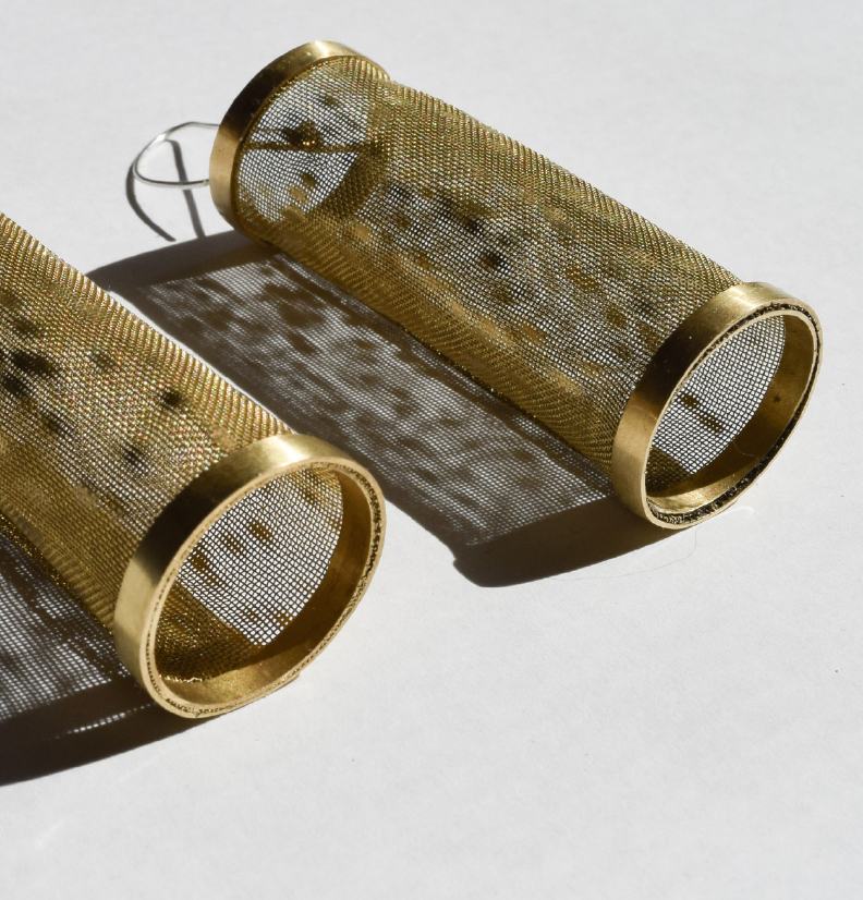 brass earrings, made from wire and woven wire mesh with light reflecting from the surface.