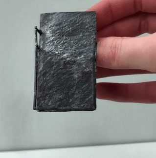moving image of grey rectangle brooch, showing light reflecting at different angles