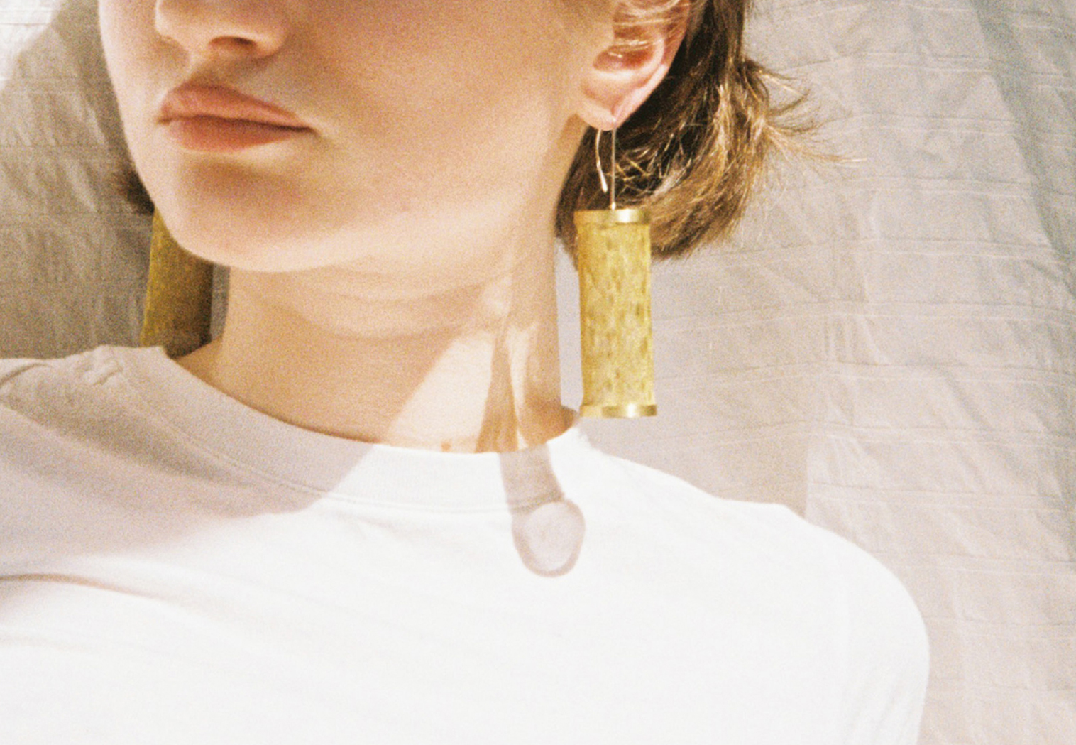 person wearing brass earrings