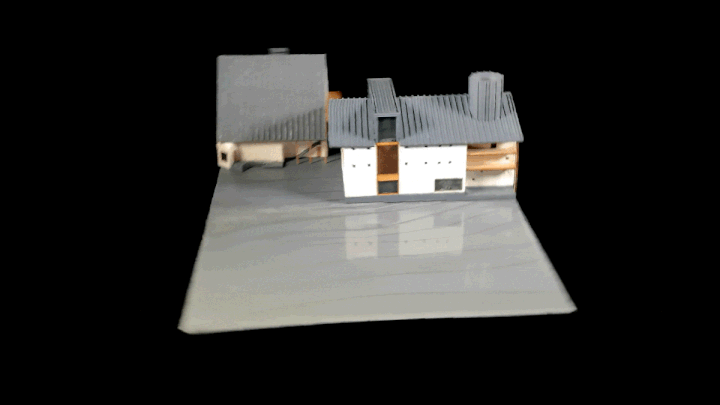 A handcrafted model of epoxy resin, plaster, and plywood spins in space.