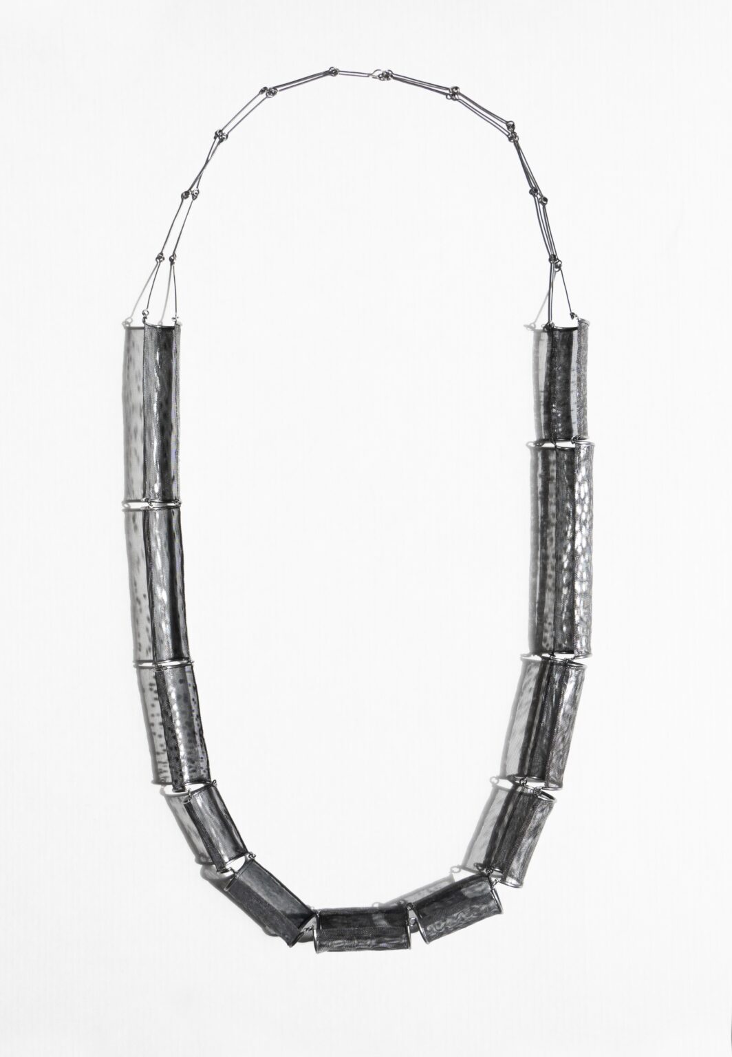 necklace laid out flat on a white background