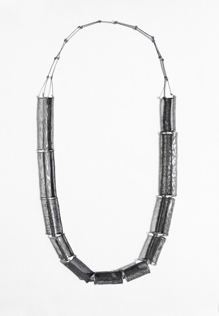 necklace laid out flat on a white background